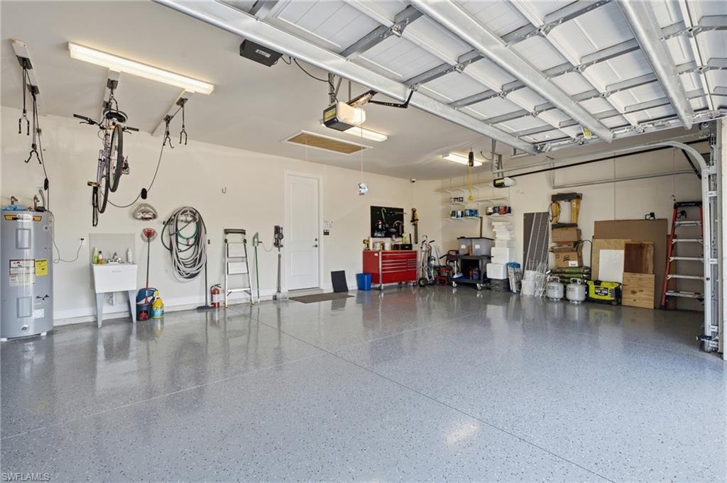 Epoxy-coated flooring, built-in utility sink, and wall-mounted storage racks