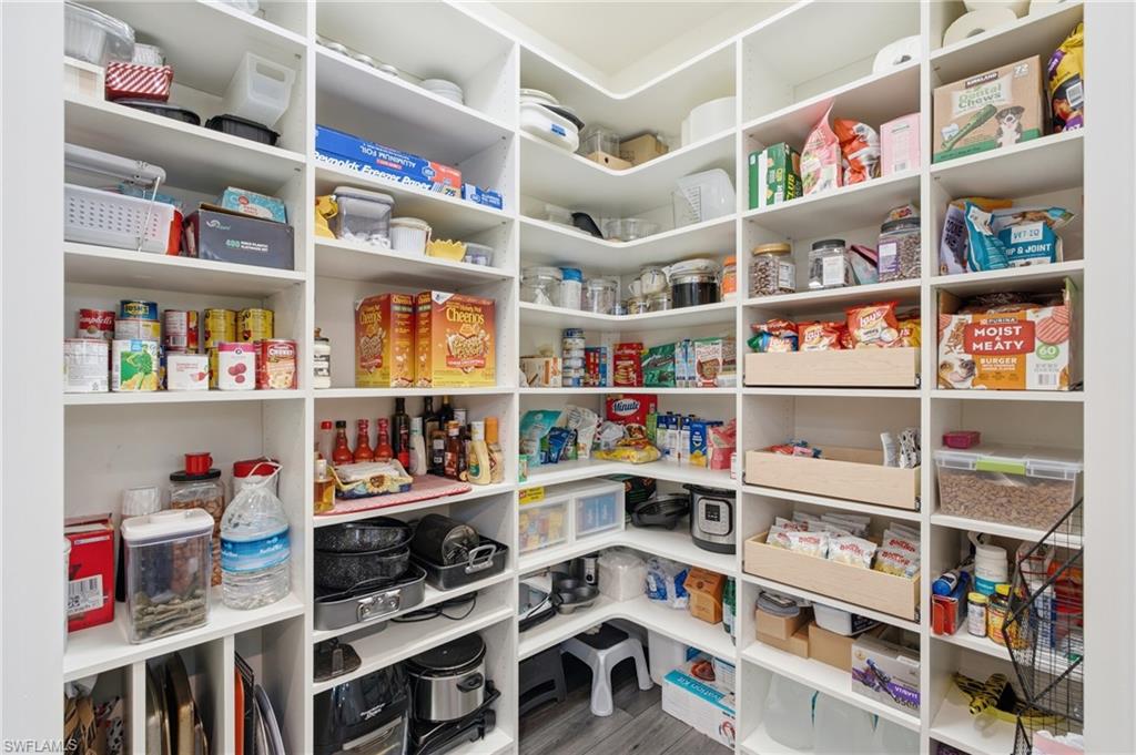 Built-in white shelving system with varying shelf heights, designed for organized storage