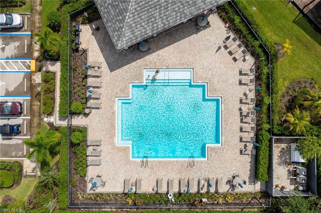 Geometric swimming pool with integrated steps, surrounded by a paver deck
