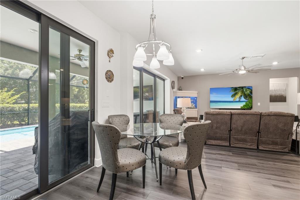 Open-concept living space with wood-finish flooring, recessed lighting, and a ceiling fan