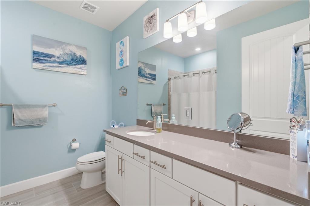 Full-width vanity with dual sinks, undermount basin, and ample counter space