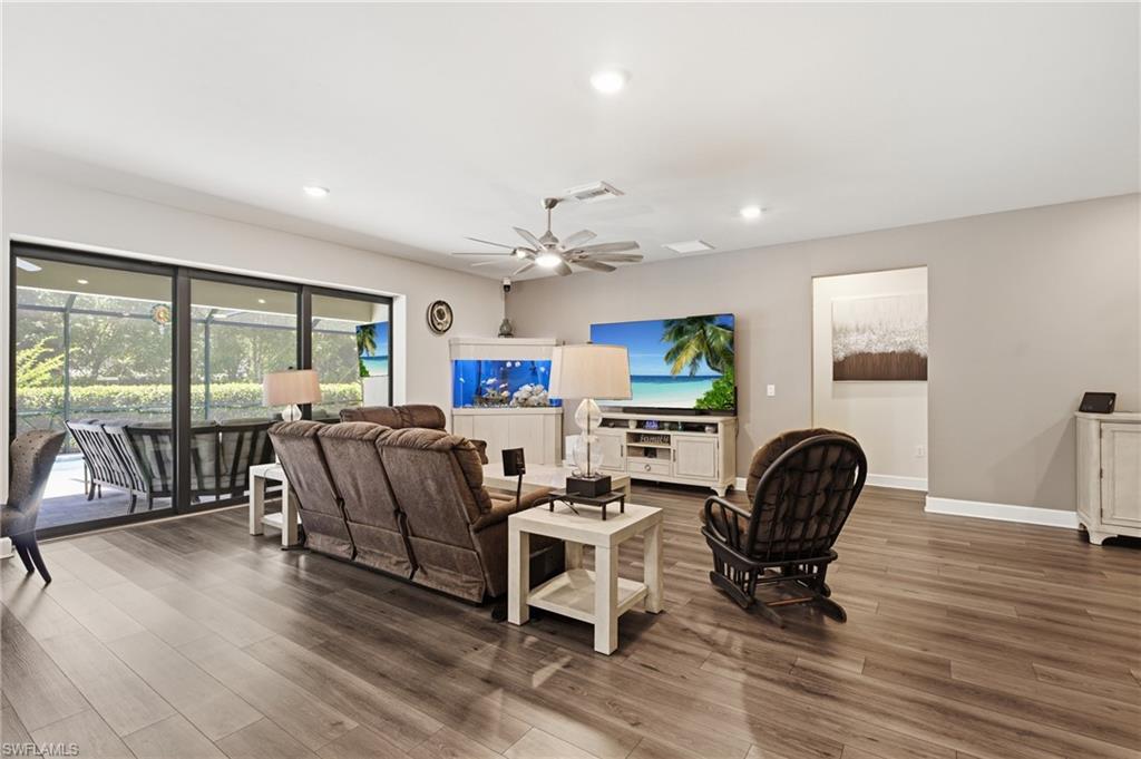 Wood-finish flooring, recessed lighting, and a ceiling fan with light