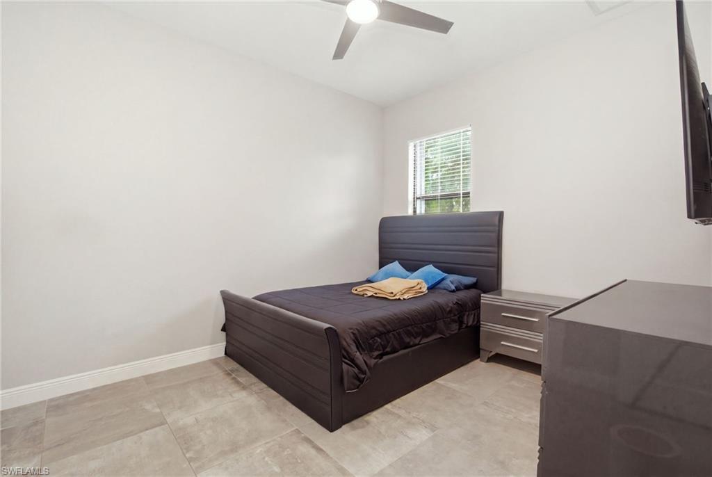 Recessed ceiling fan, window with blinds, and durable tile flooring