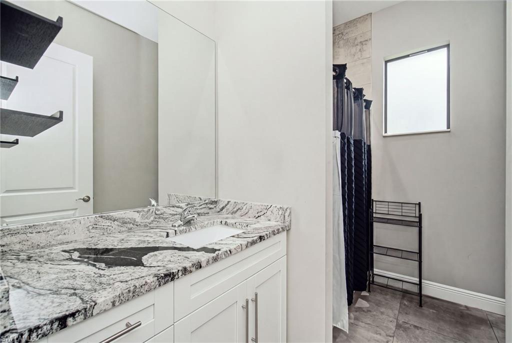 Dual vanity with a stone countertop and two integrated sinks