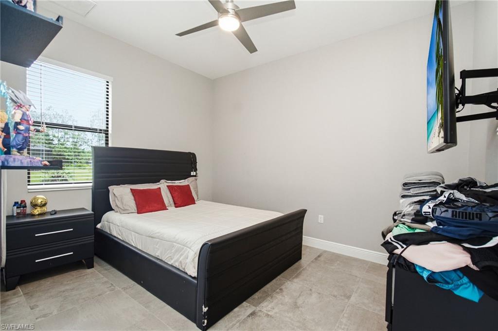 Recessed lighting, ceiling fan, window with blinds, and tile flooring