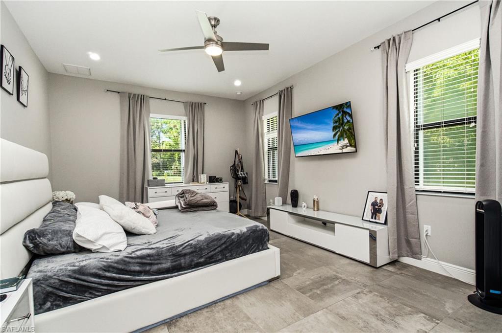 Recessed lighting, ceiling fan, and wood-finish flooring