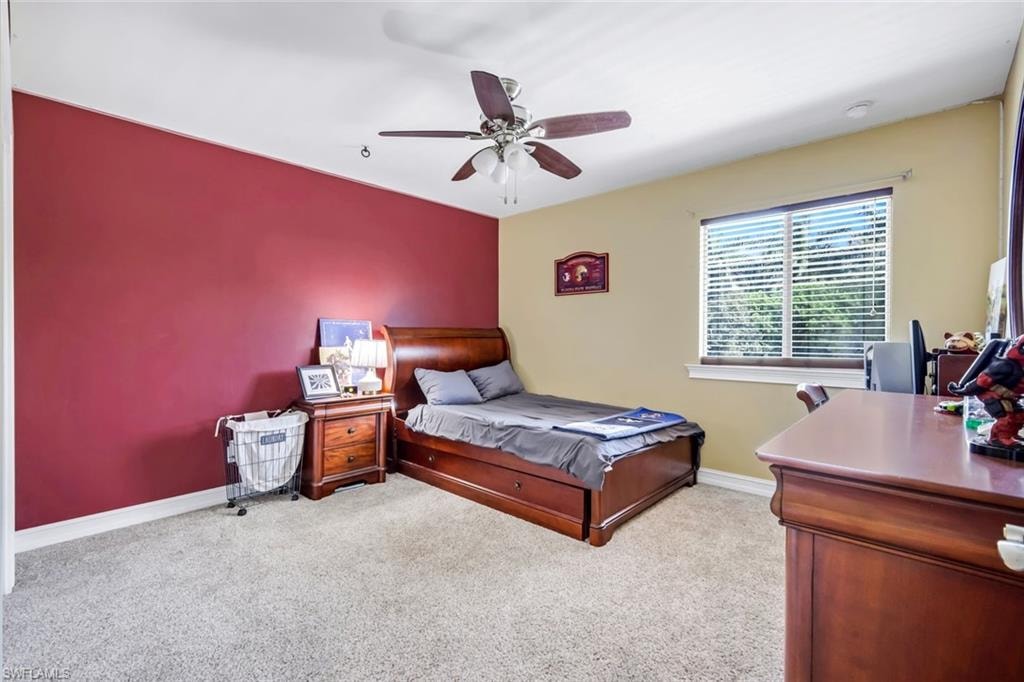 Carpeted room featuring a ceiling fan, window with blinds, and recessed lighting