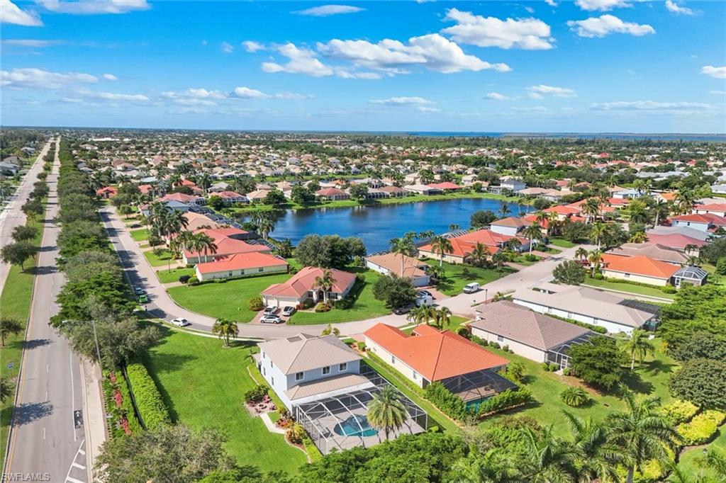 Aerial perspective showcasing a residential community with a central lake