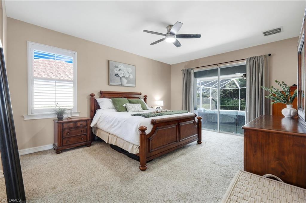 Carpeted flooring, ceiling fan with integrated lighting, glass sliding doors, window with horizontal blinds