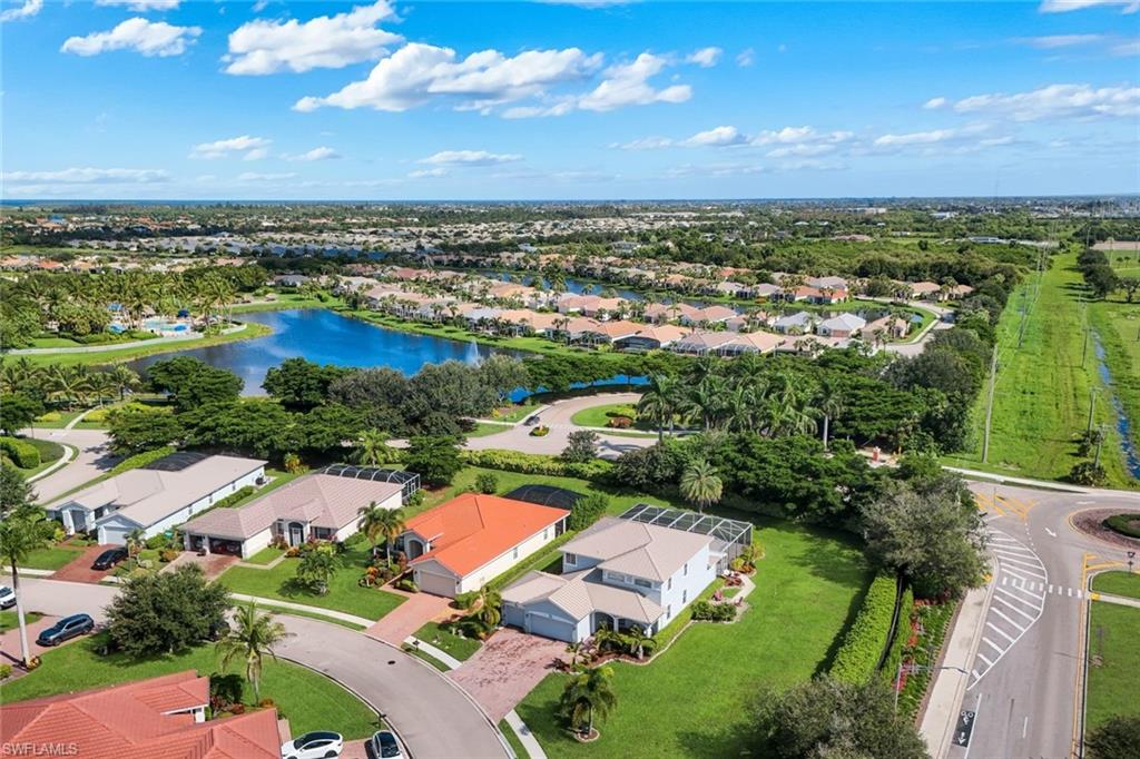 Expansive community showcasing a large central lake, mature landscaping, and an organized street layout