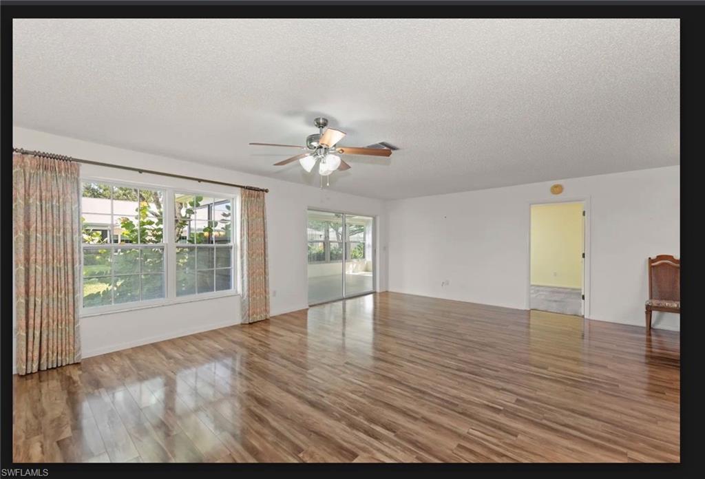 Open floor plan sliding glass doors to huge sun room