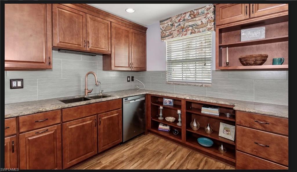 Upgraded kitchen granite counter, copper color sink, wood color cabinets shelves for your favorite figurines, etc.