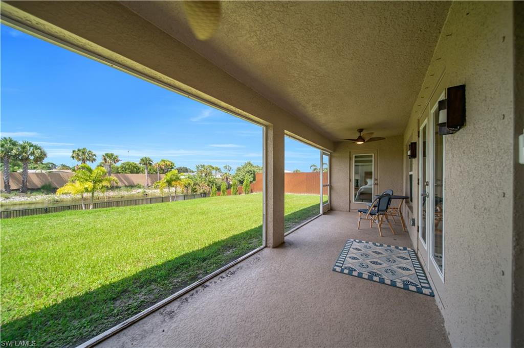 Screened-in patio with textured flooring and ceiling fan