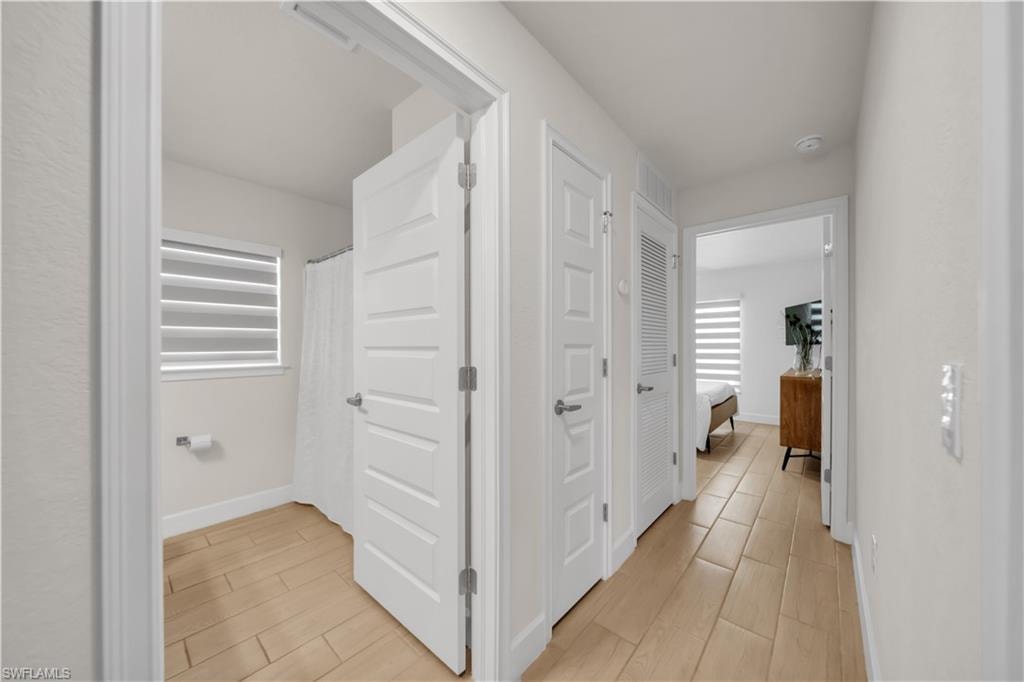 Neutral wall tones, recessed lighting, and wood-finish flooring