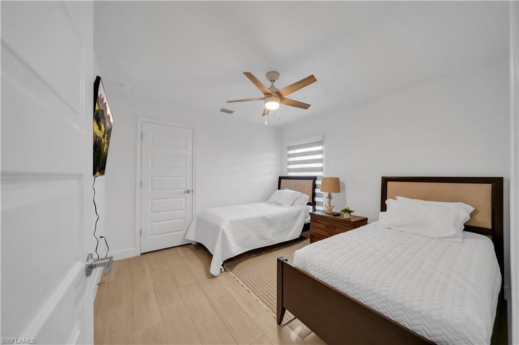 Hardwood-look flooring throughout, five-panel interior doors, and a ceiling fan with integrated lighting