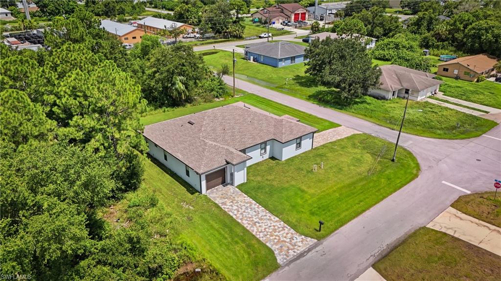 Single-story residence with a light-toned exterior, an attached garage, and a patterned driveway