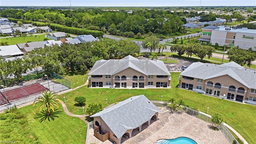 Multiple residential buildings with light-colored exteriors and shingled roofs