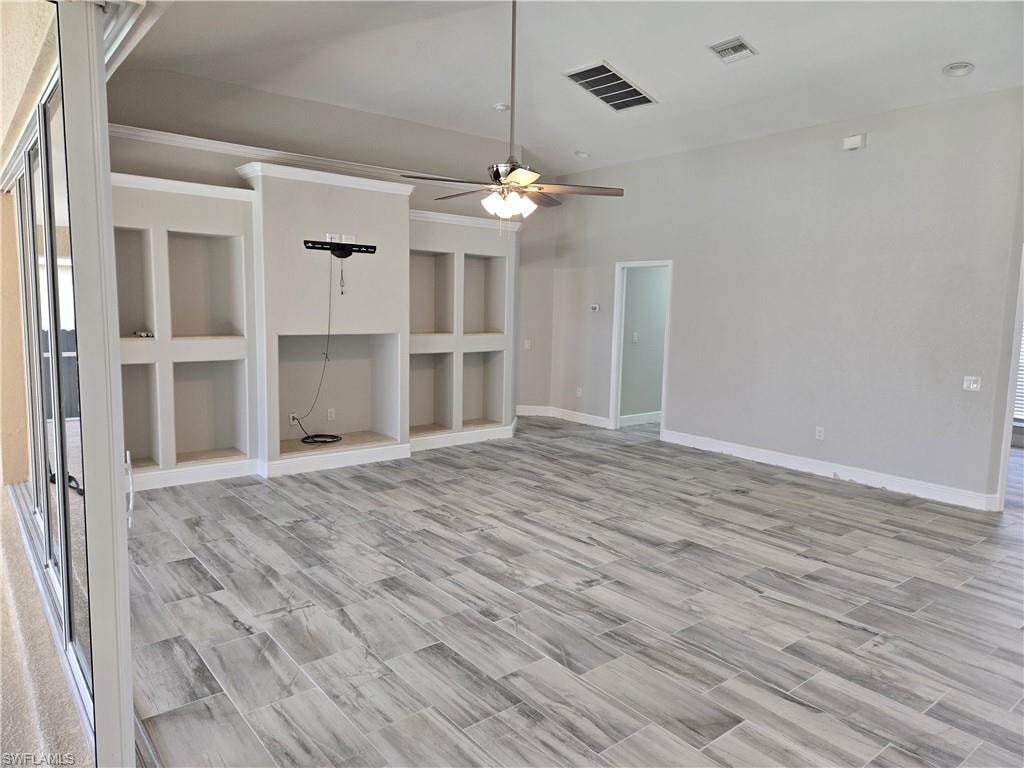 Spare room with a ceiling fan and light wood finished floors