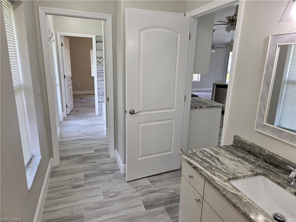 Hall featuring a sink and light wood-type flooring