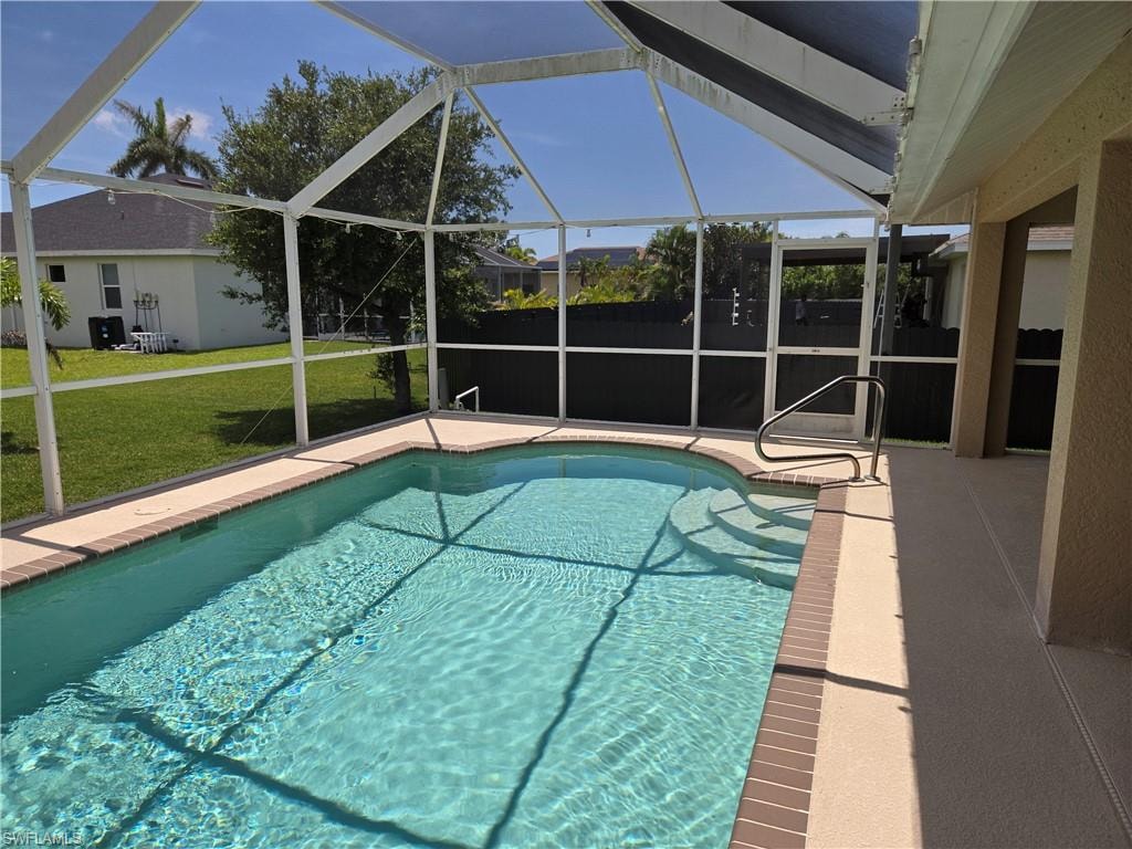 Outdoor pool with a patio, a lanai, and a yard