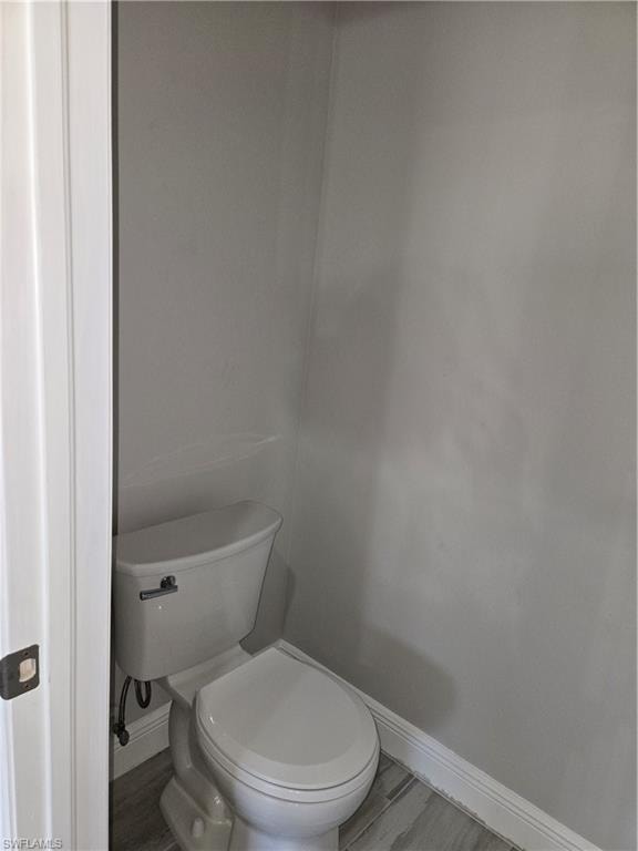 Bathroom featuring baseboards and wood finished floors