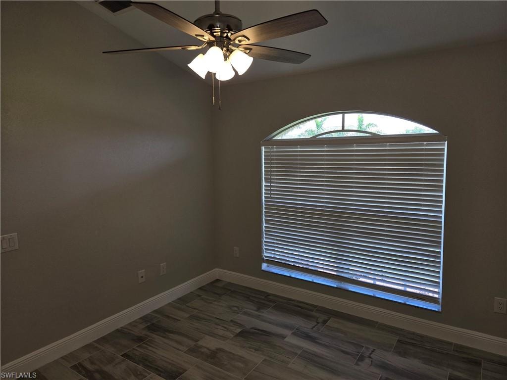 Unfurnished room with a ceiling fan and wood finish floors