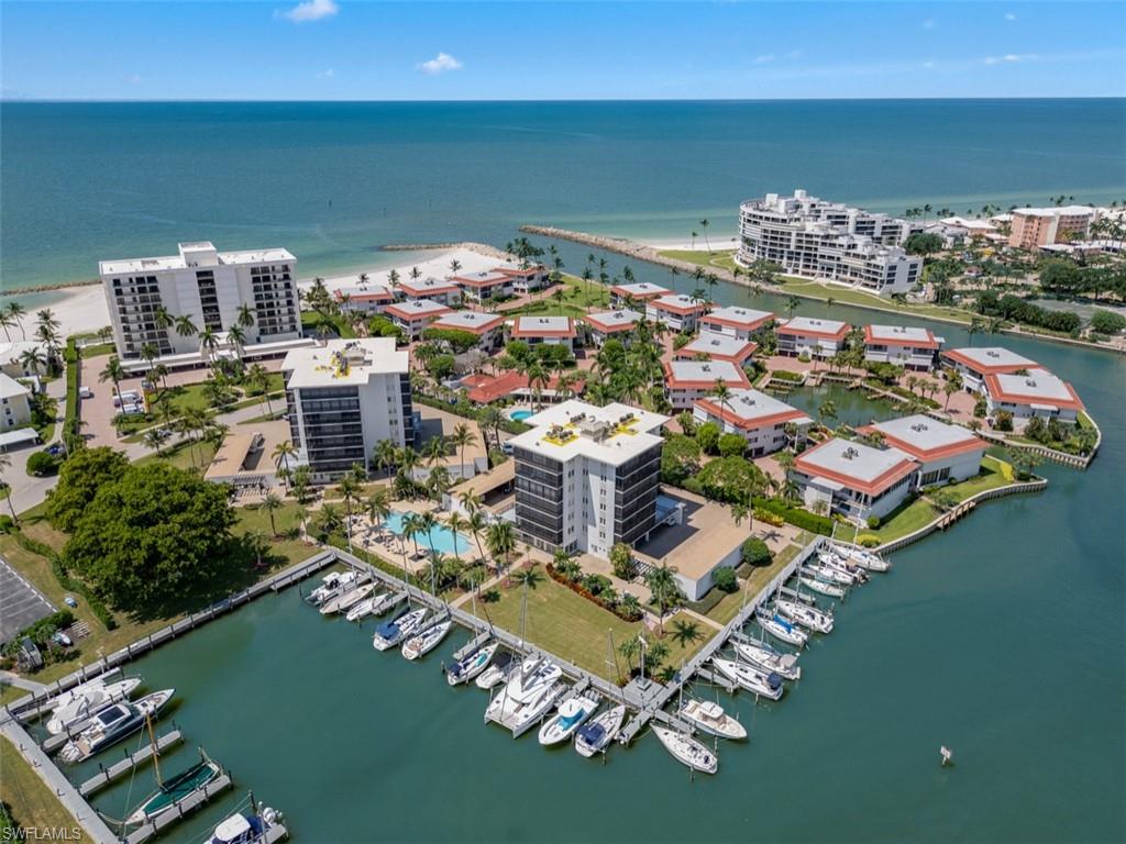 Coastal community featuring multiple high-rise and low-rise residences, private boat docks, and a swimming pool