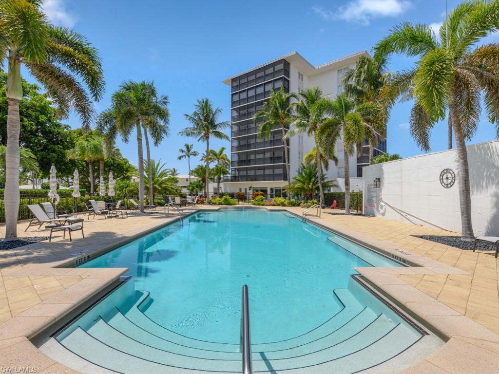 Expansive swimming pool with integrated steps, surrounded by a paver deck