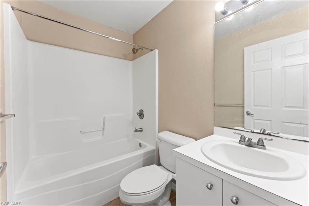 Full bath with toilet,  shower combination, and vanity