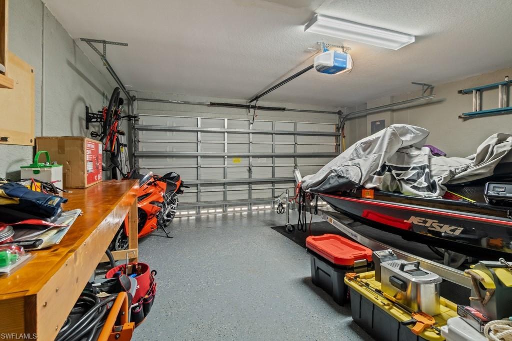 Garage space featuring a built-in workbench, overhead lighting, and an automatic garage door opener