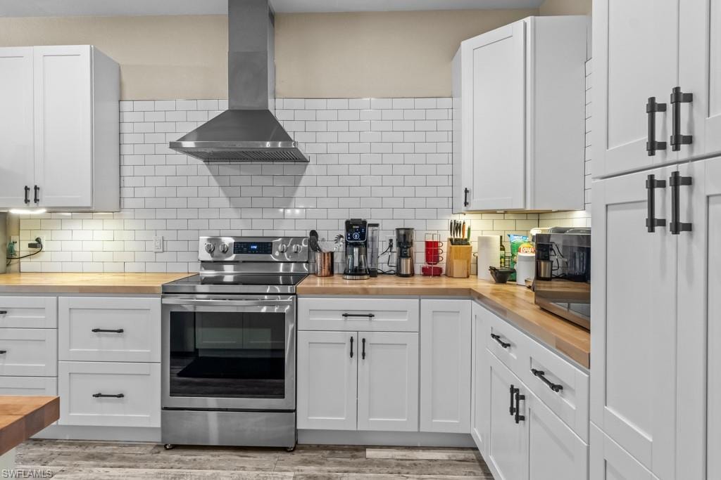White shaker cabinetry paired with wood-finish countertops