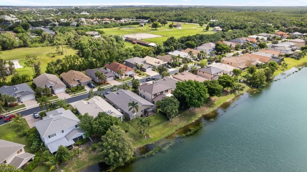 Waterfront properties featuring diverse architectural styles, mature landscaping, and residential street access