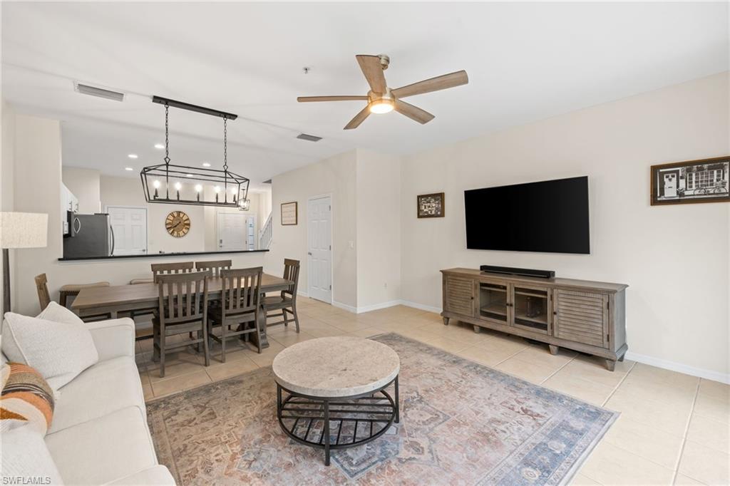 open living room and dining area . 1/2 bath, entry way and door from garage to the kitchen.