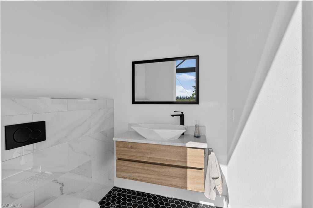 Pool bathroom featuring vanity and tile patterned floors