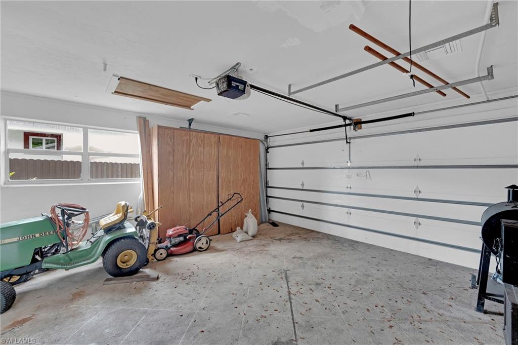 Garage with overhead door, concrete flooring, and horizontal windows