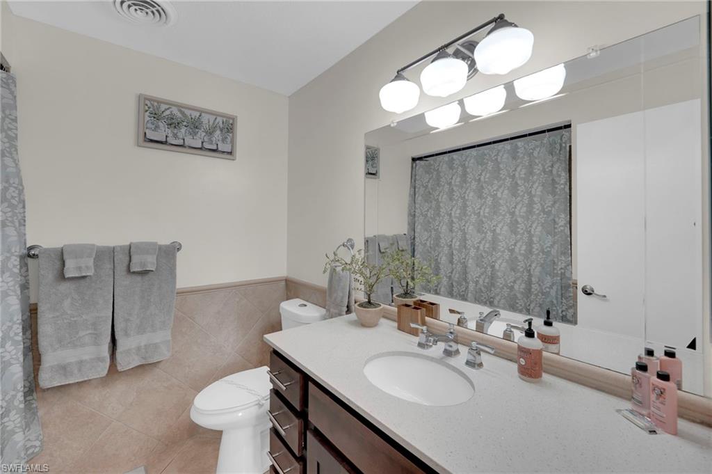 Vanity with an integrated sink, polished chrome faucet, and ample under-sink storage