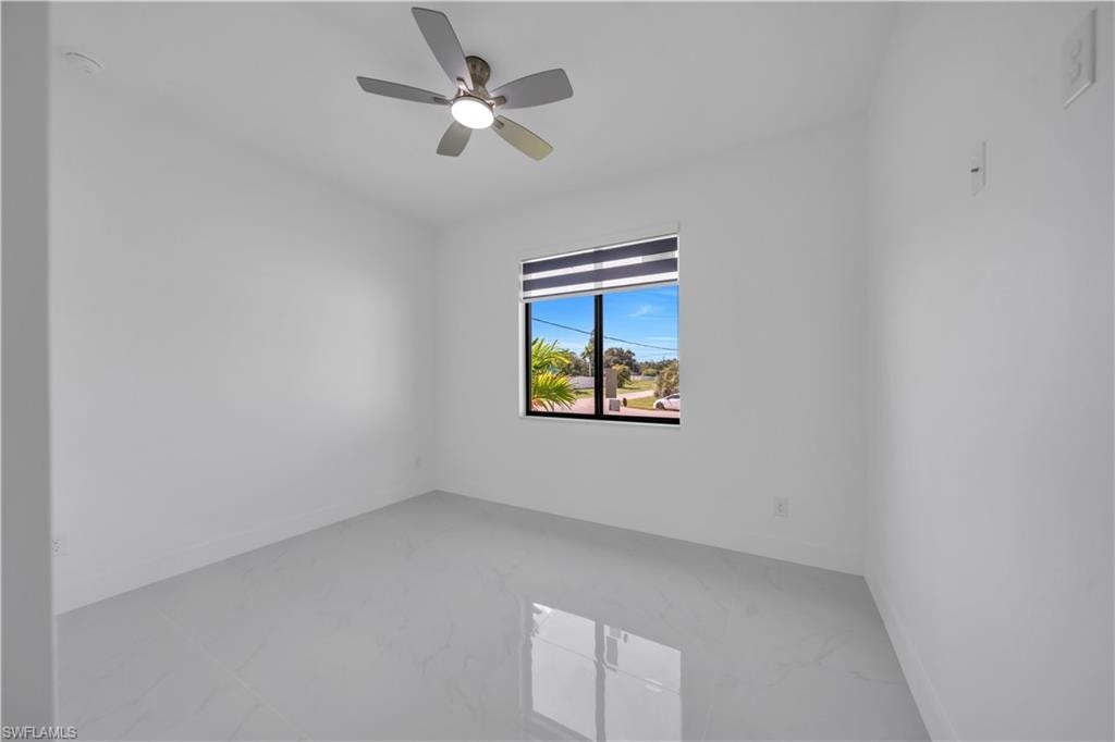 Recessed ceiling light, ceiling fan with integrated lighting, window with horizontal blinds, and tile flooring