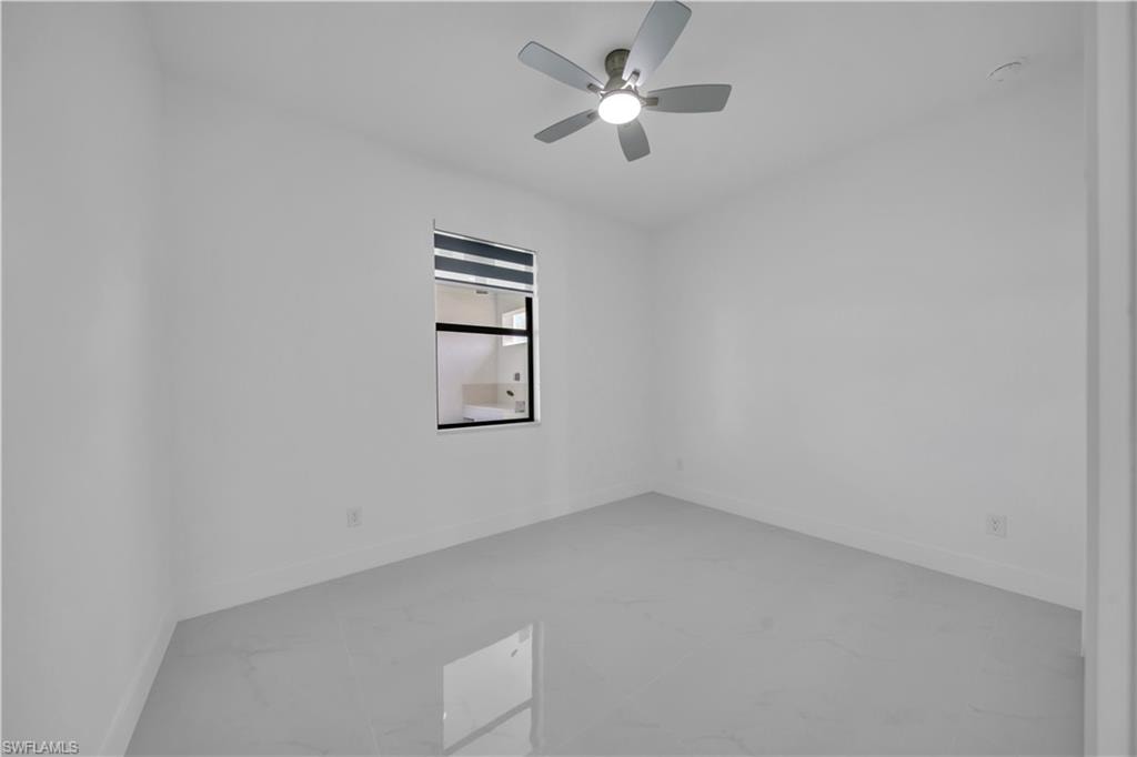 Recessed lighting, ceiling fan with integrated light, window with privacy blinds, and tile flooring