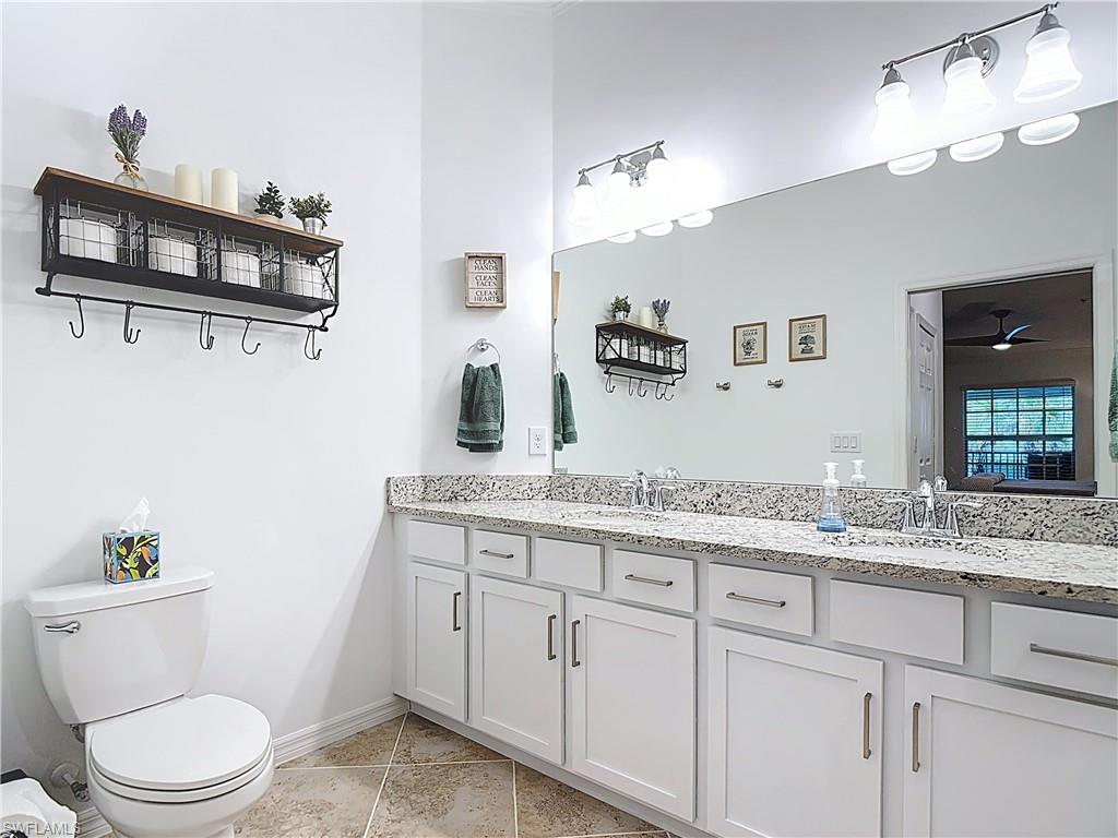 Bathroom featuring toilet and light tile patterned flooring