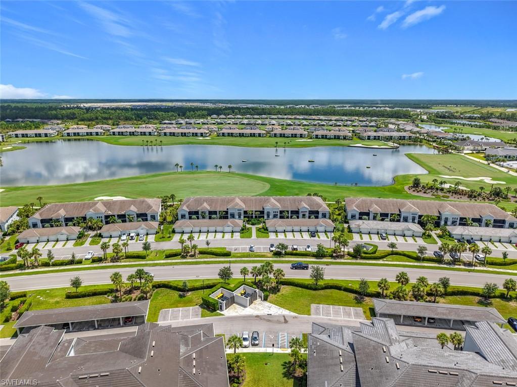 Aerial view of residential area featuring a large body of water and a golf club