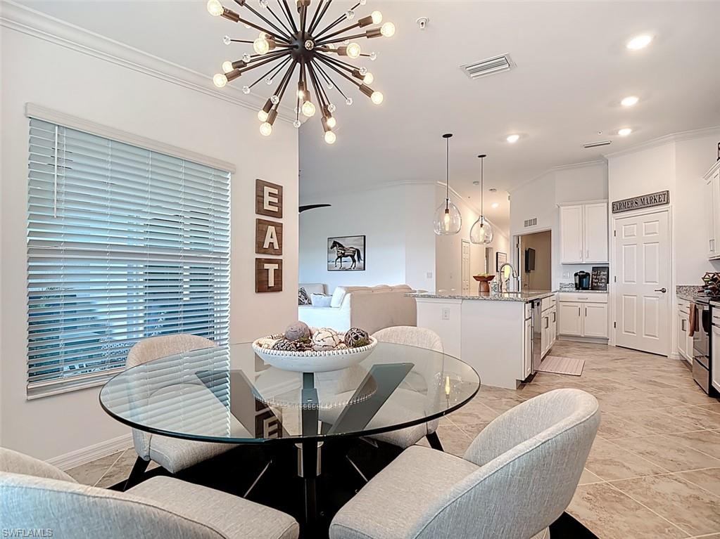 Dining room featuring crown molding, recessed lighting, and a chandelier