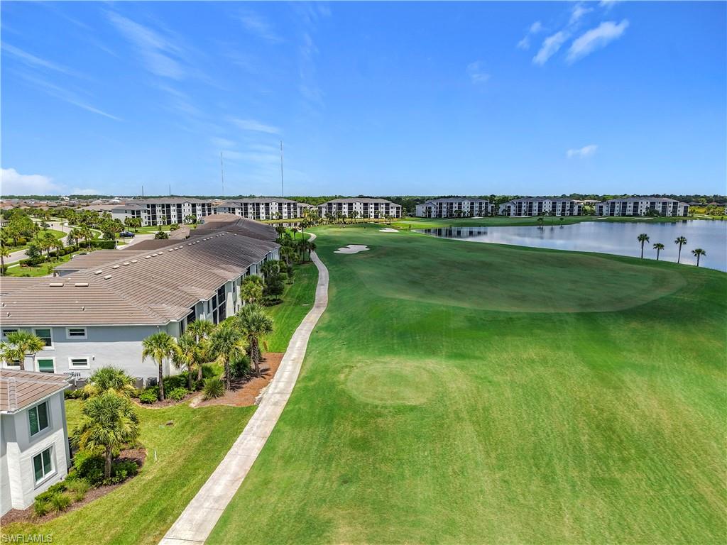 Drone / aerial view of a nearby body of water and a golf club