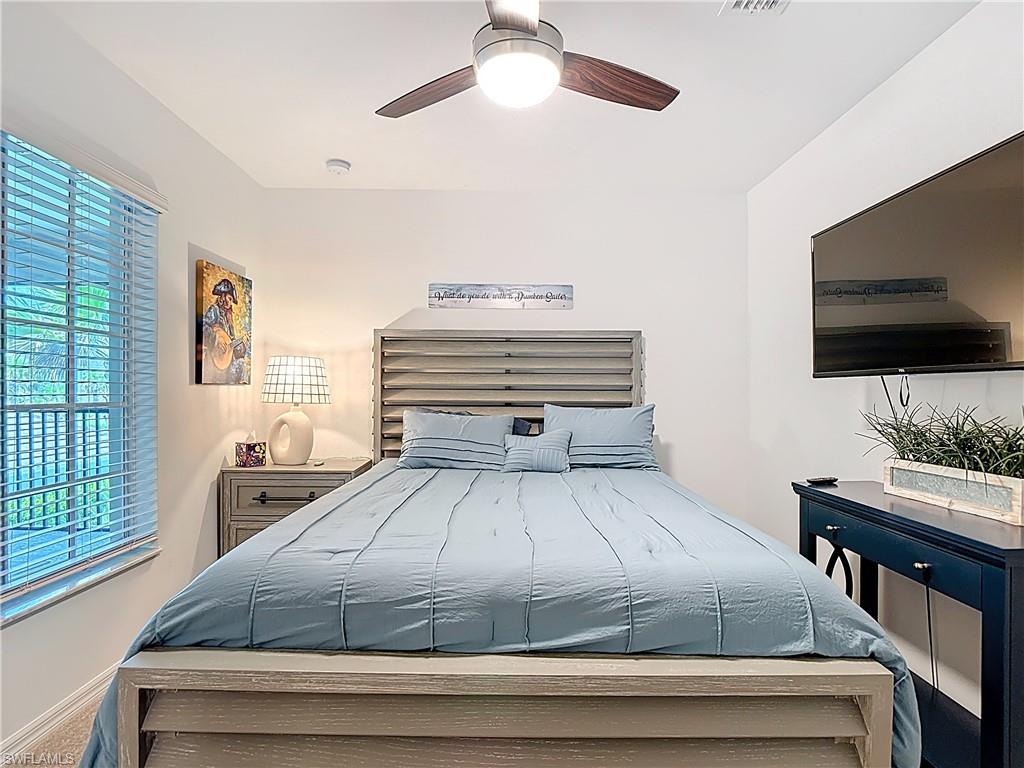 Bedroom with a ceiling fan and baseboards