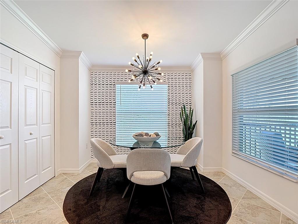 Dining area featuring a chandelier, ornamental molding, and healthy amount of natural light
