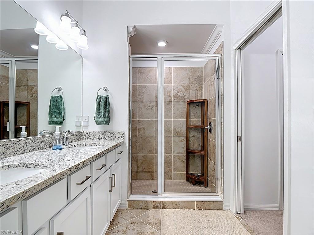 Bathroom with a stall shower and light tile patterned floors