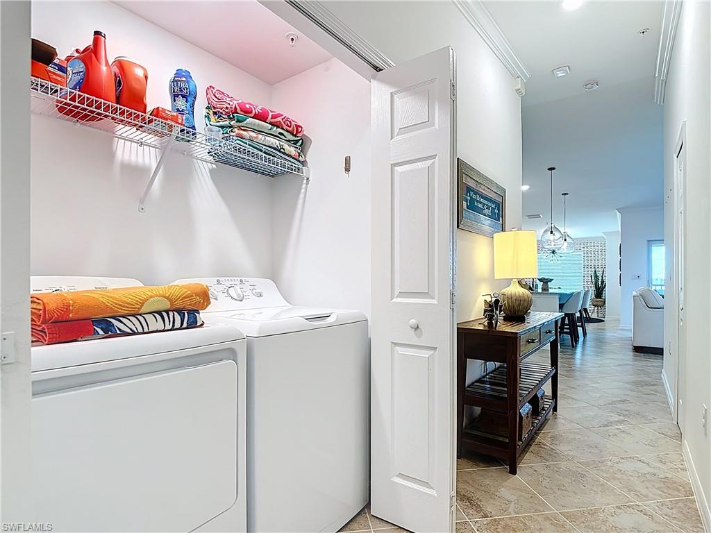 Washroom featuring separate washer and dryer, recessed lighting, and light tile patterned flooring