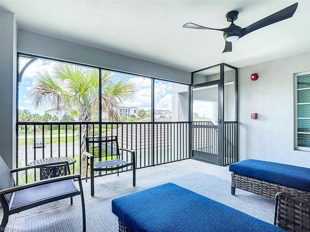 Sunroom featuring a textured wall and carpet flooring