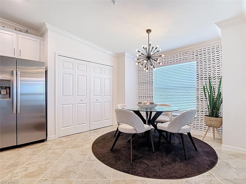 Dining space featuring ornamental molding and a chandelier