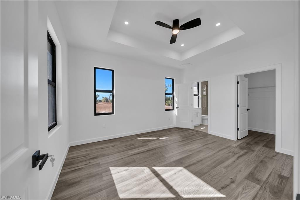 Recessed ceiling with a modern ceiling fan and integrated lighting