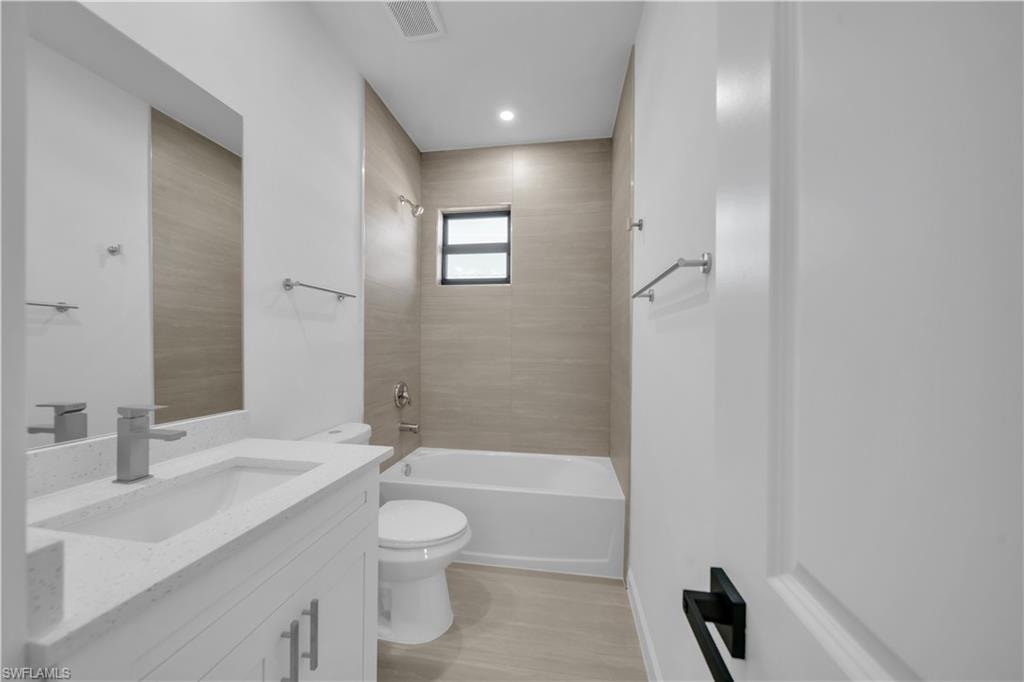 Modern bathroom featuring a single vanity with a white countertop, undermount sink, and brushed nickel faucet